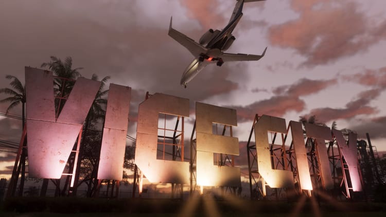 Vice City letter billboard, lit up during sundown, with a plane flying over.